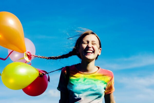 Balloons are tied to the girl by both braids