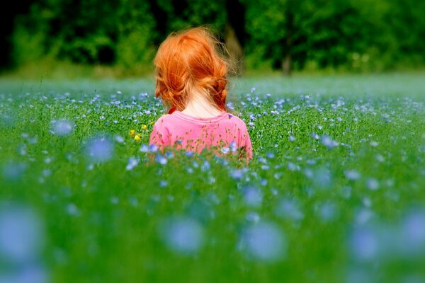 Sunny girl with red hair with radish grass