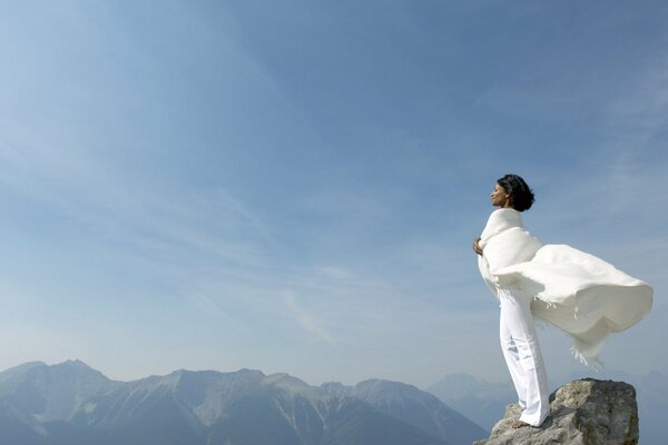 The girl in white stands at the top