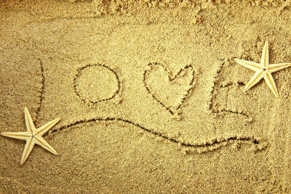 Image of the word of love and stars on the sand