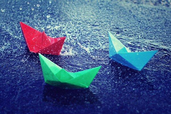 Three colored paper boats from childhood