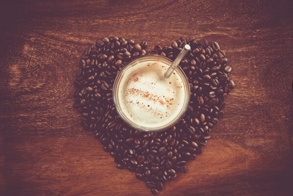 Hot coffee on the background of coffee beans