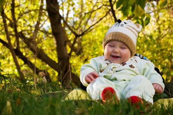 Laughing baby on the grass in the park