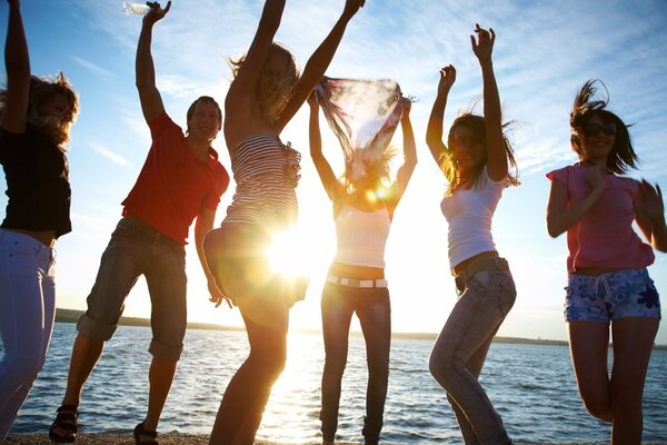 Dance of beautiful girls at sunset