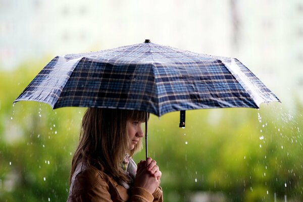 A girl walks in the rain