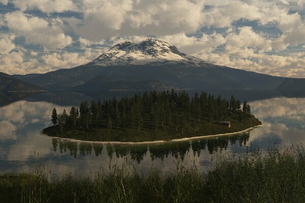 An island in a lake on the background of a mountain