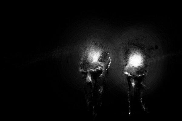 Silhouettes of skulls on a black background