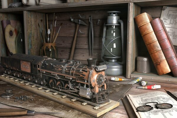 A small train on the table among books, tools