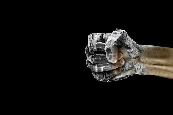 Stone fist on a black background