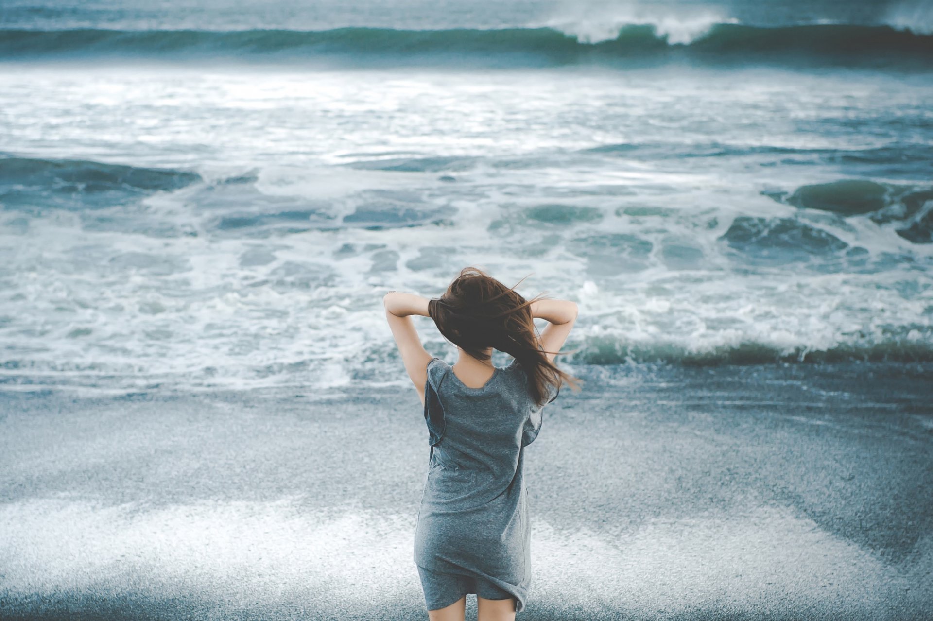 girl beach waves wind