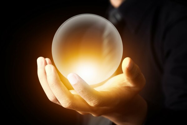 Magic crystal ball in hand