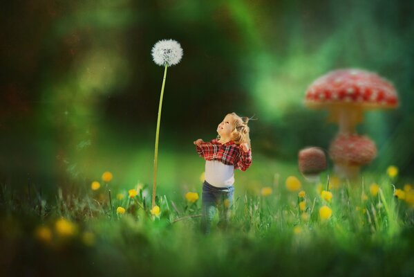 A little girl and a huge dandelion in a clearing