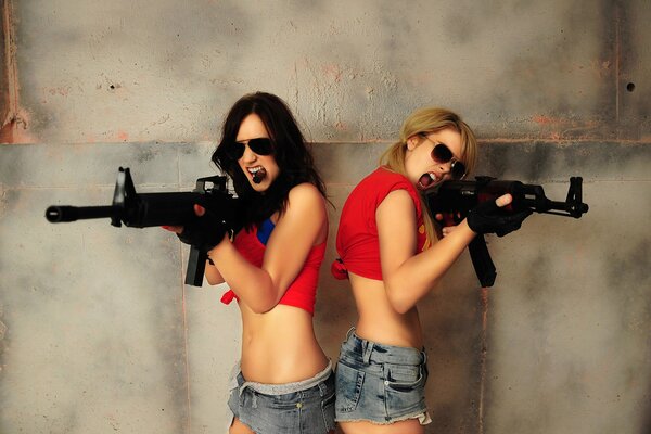 Girls in sunglasses with guns