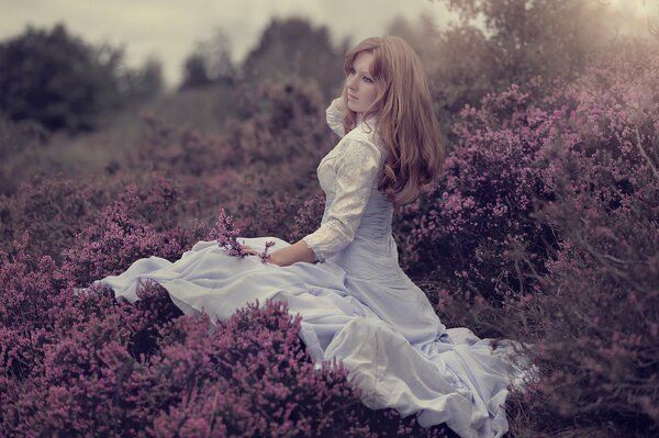 A girl in a blooming meadow