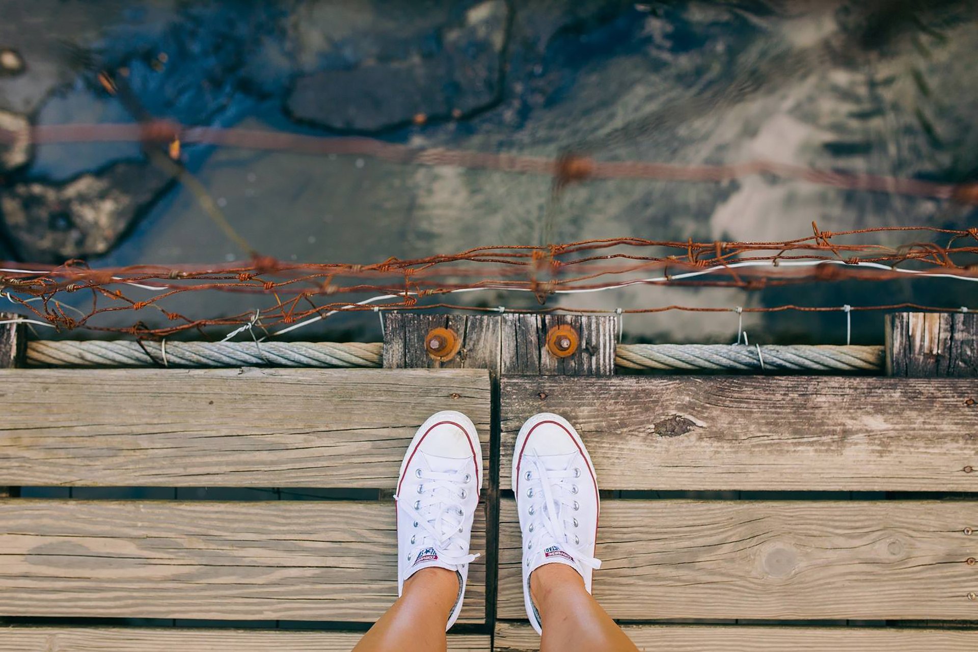 legs sneakers shoes bridge bridge river view angle top