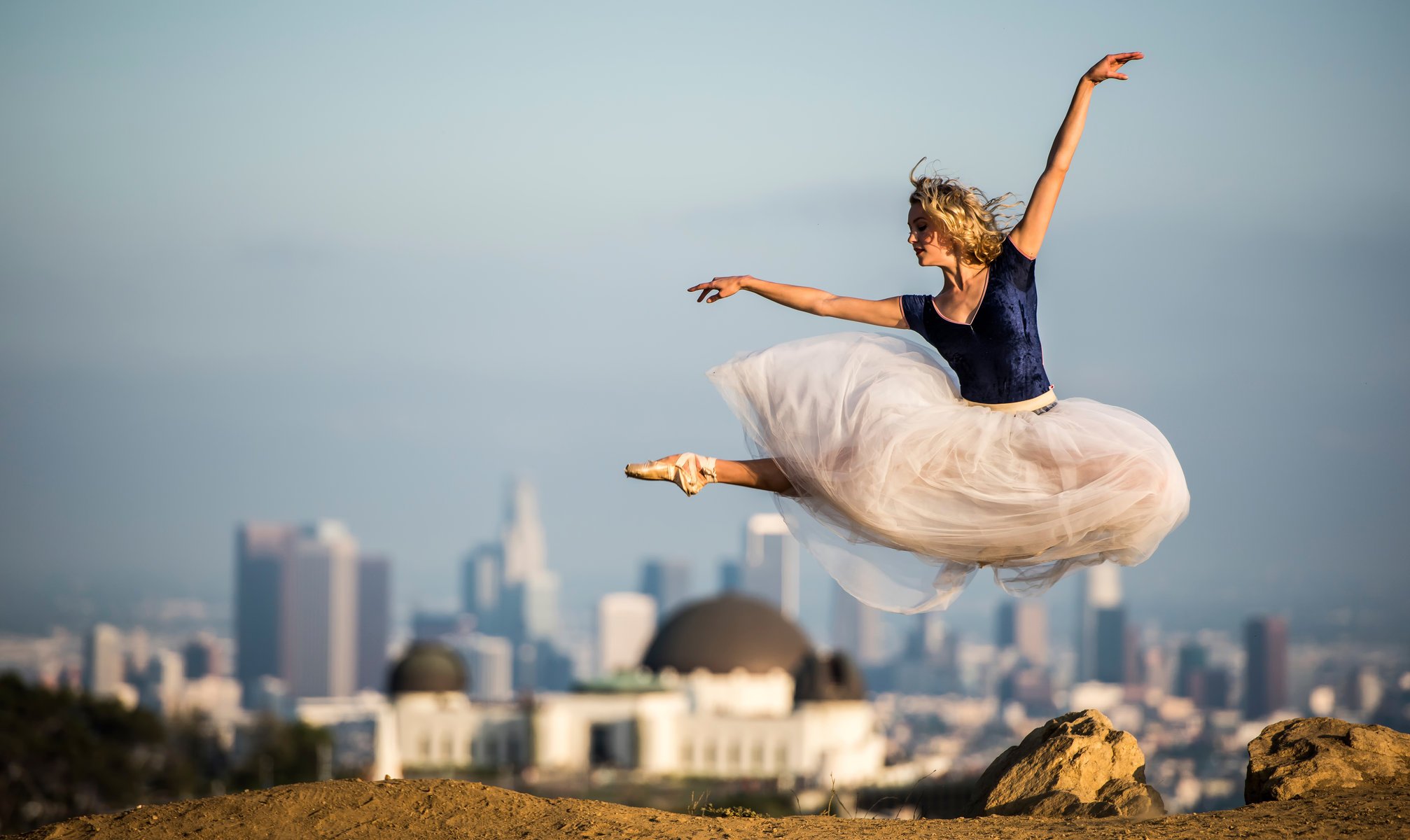 hermoso ballet bailarina zapatos de punta vestido salto en el fondo ciudad