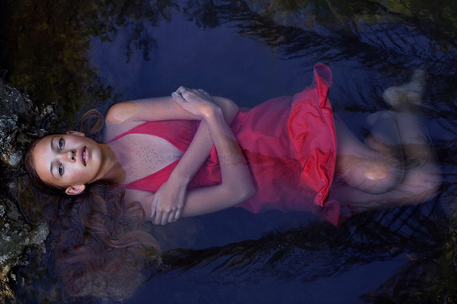 girl in red wet in water view cleavage