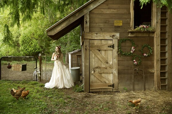 A girl bride in a white dress in the village