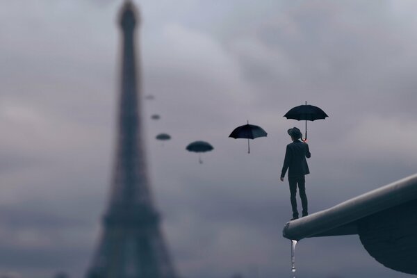 Homme sur le bord avec des parapluies jusqu à la tour