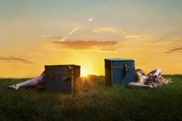 A girl in a golden dress performs a box trick at sunset