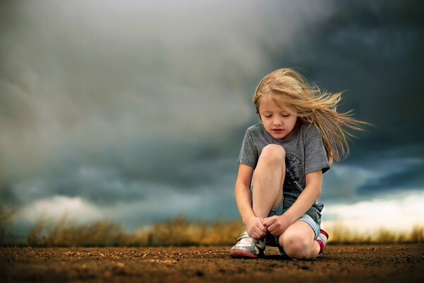 A girl under the clouds on the road