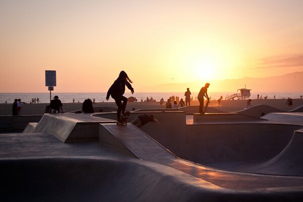 Performs tricks on a skateboard in Venice