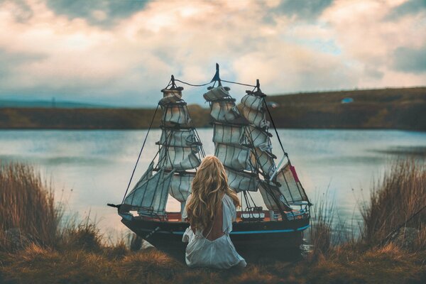 A girl with a ship on the shore