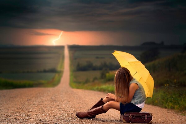 Photo of a girl with an umbrella on the road