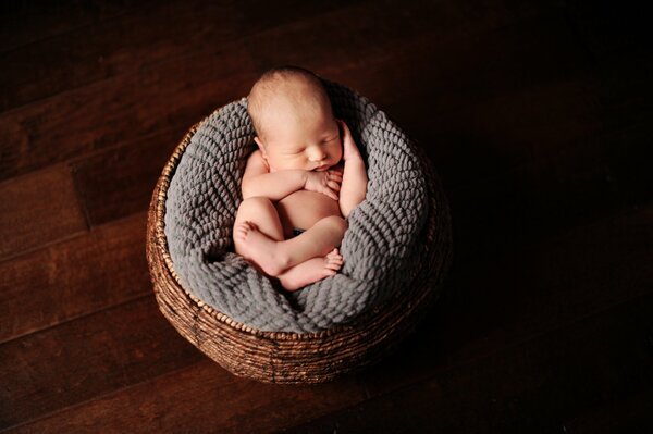 The baby sleeps in the basket