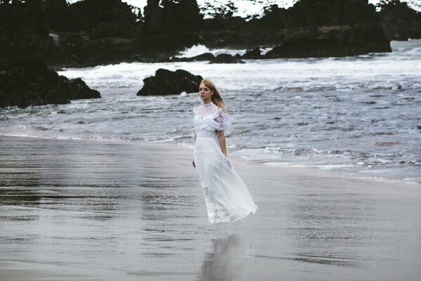 A girl in a dress on the shore