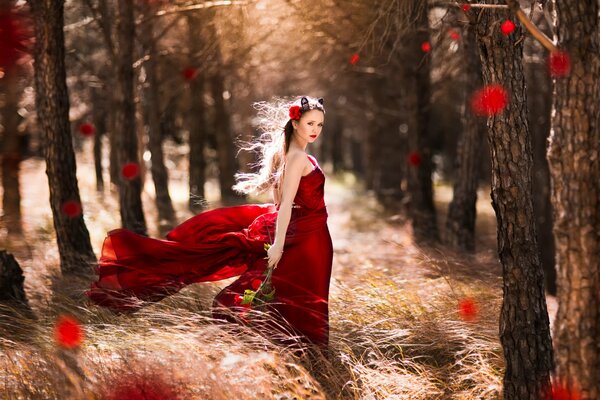 Mädchen im roten Kleid im Wald