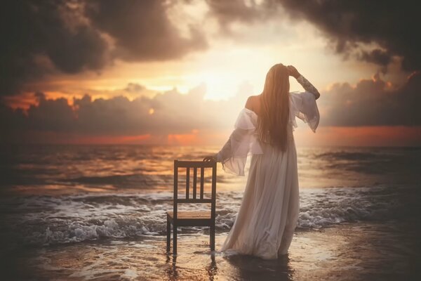 Forsaken photo with a girl by the sea and a chair