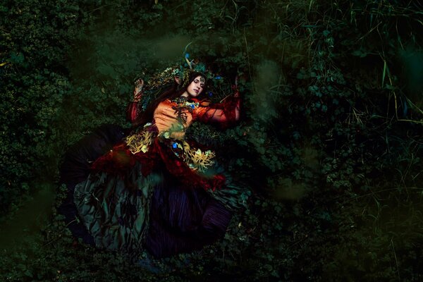 The girl is lying on a beautiful forest moss