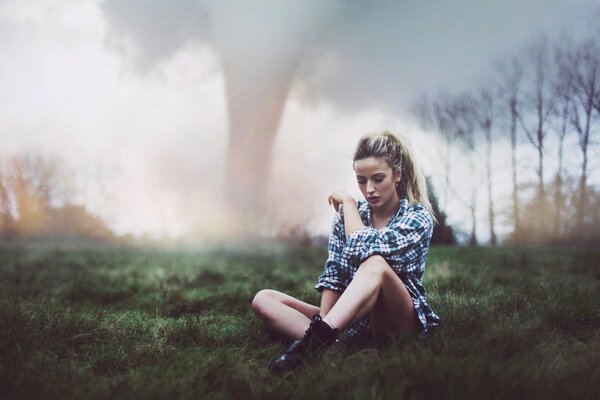 A girl sitting on the ground after a tornado