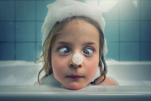 A girl washes in a bubble bath