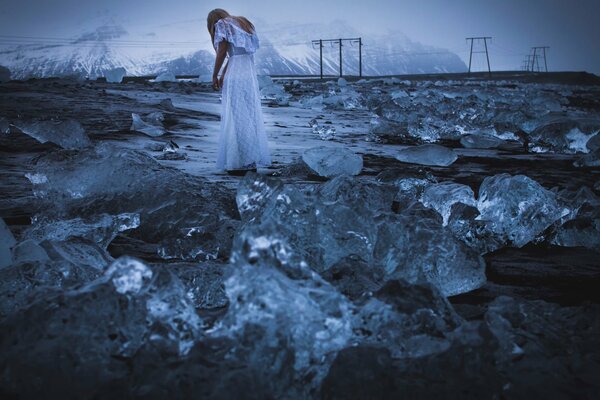 A girl in a white dress in the mountains