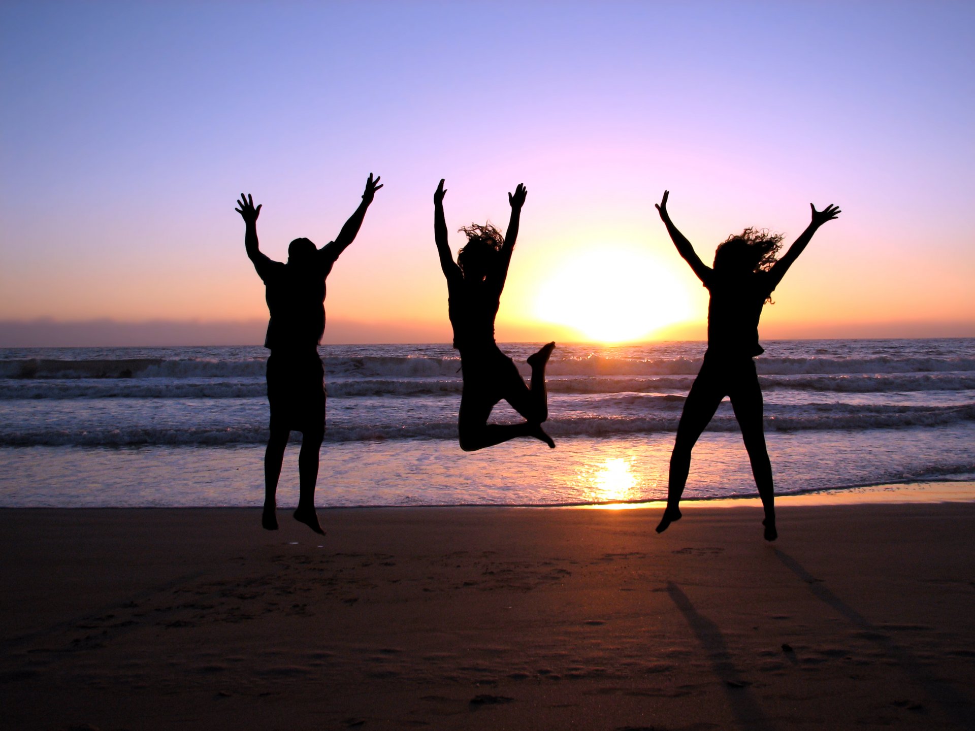 three joy jump girls guy sea sunset shore beach