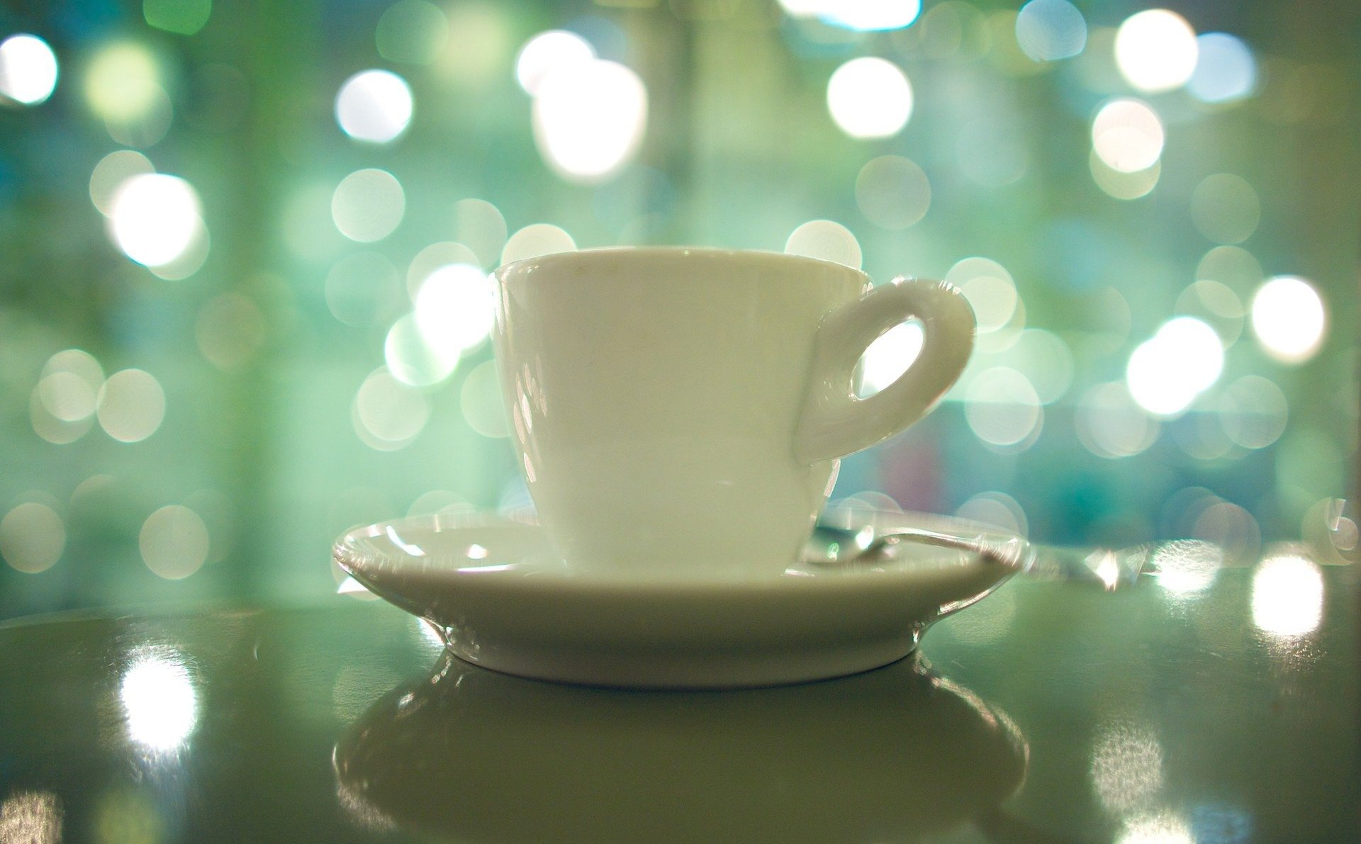 cup saucer spoon reflections light morning mood close up