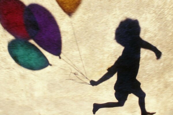 The shadow of a boy with balloons