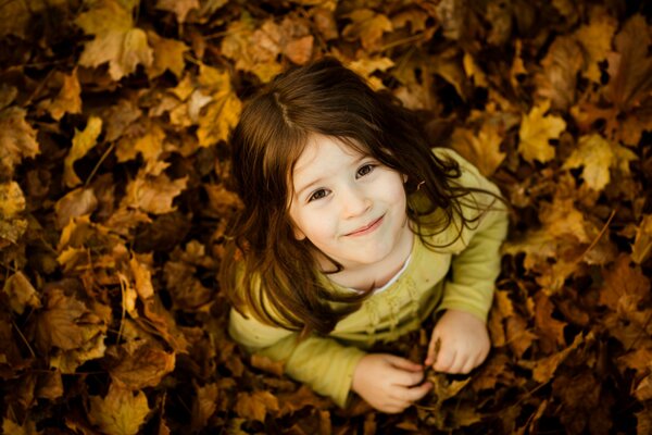 Cute girl in golden foliage