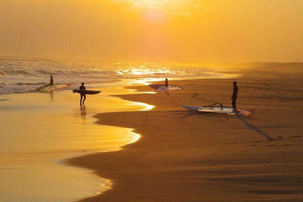 People on the ocean on the background of sunset