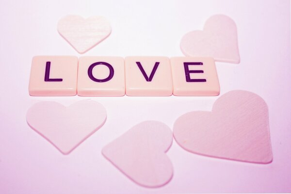 The inscription LOVE and pink hearts