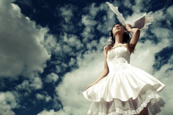 The bride on the background of the sky and clouds