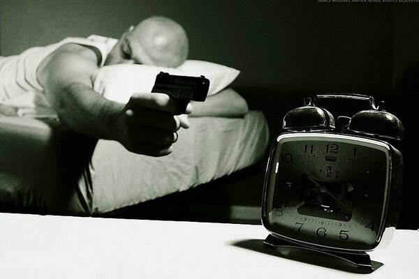 A man shoots an alarm clock