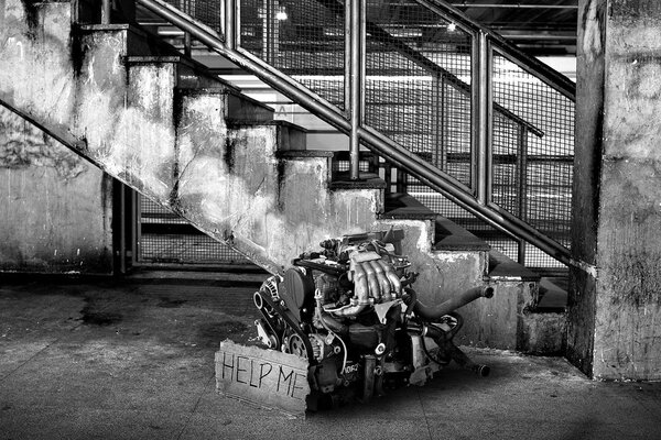 Motor under the stairs in black and white