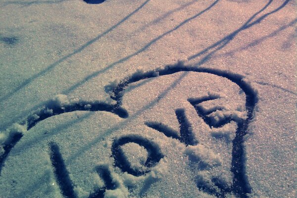 Drawing of a heart with the inscription love on ice and snow