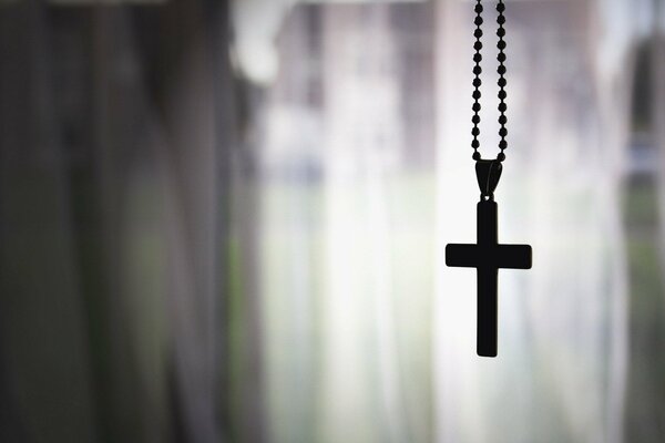 Chain with a cross on a gray background