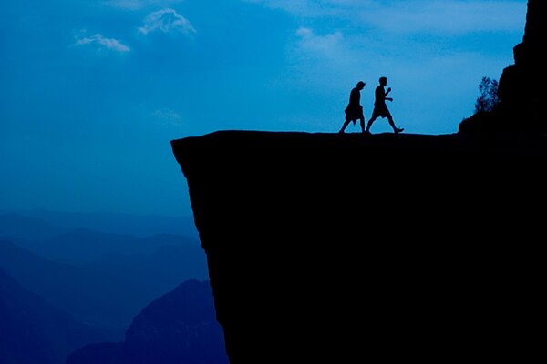 Cliff and people going into the dark