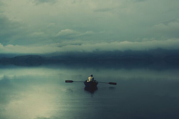 A lonely man in a boat on the lake