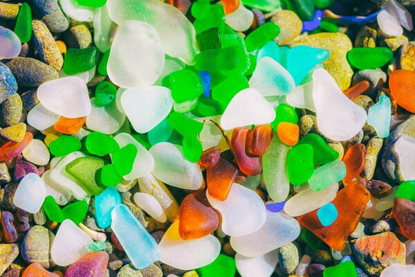 Background multicolored pebbles and glass